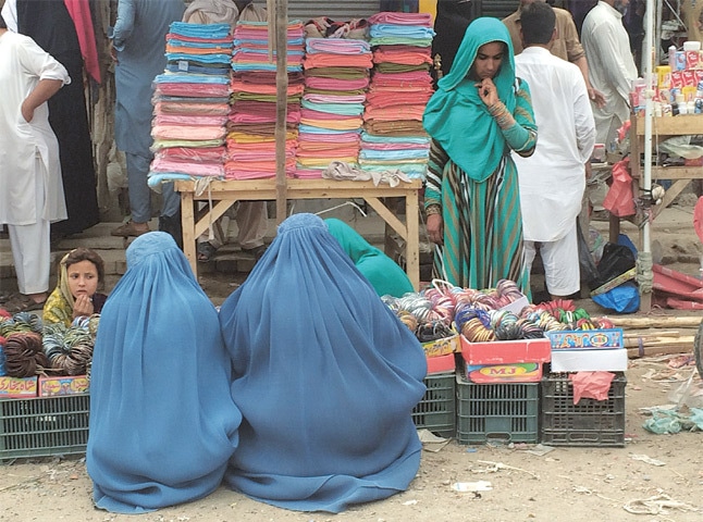 The clientele at Chhota Kabul is mostly Afghan, as are the two women here buying bangles.&mdash;Photo by writer