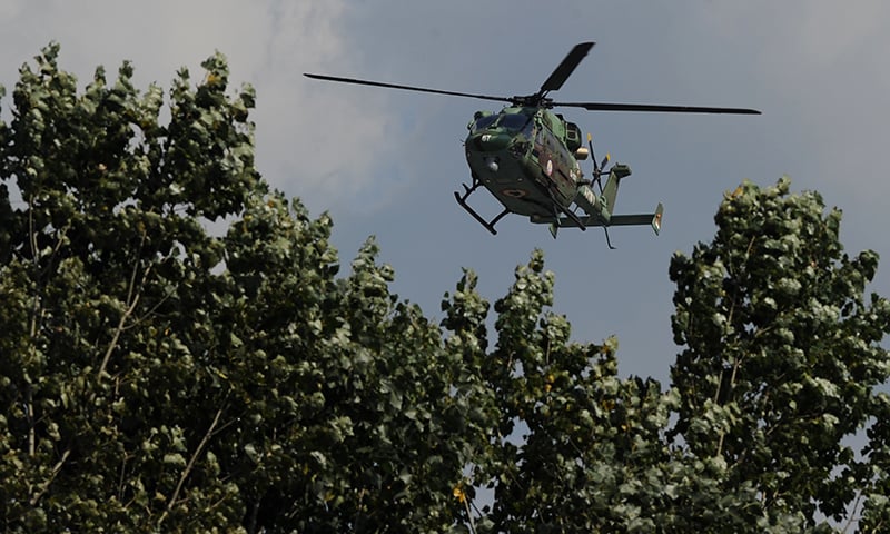 An Indian army helicopter flies over the site of a gunbattle between Indian army soldiers and suspected militants inside an army brigade headquarters near the border with Pakistan. &mdash; AFP