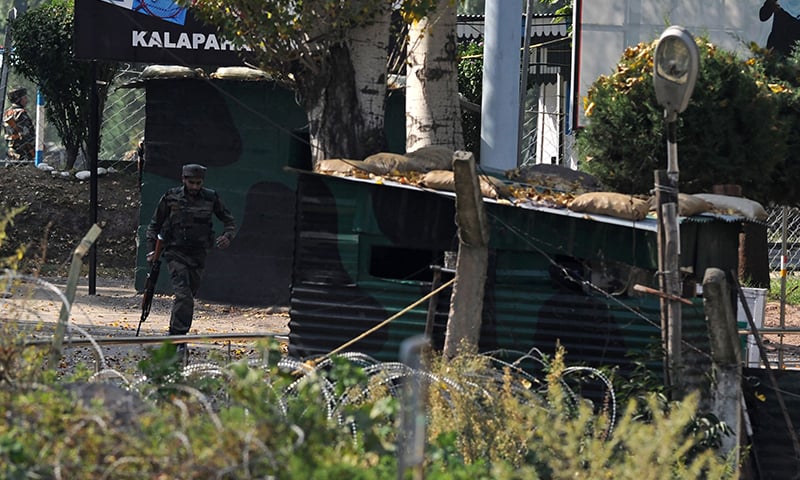 An Indian army soldier runs through an army brigade headquarters during a gunbattle.&mdash; AFP
