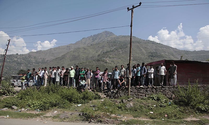 Kashmiri civilians gather outside the army base which was attacked by suspected militants in the town of Uri. &mdash; AP