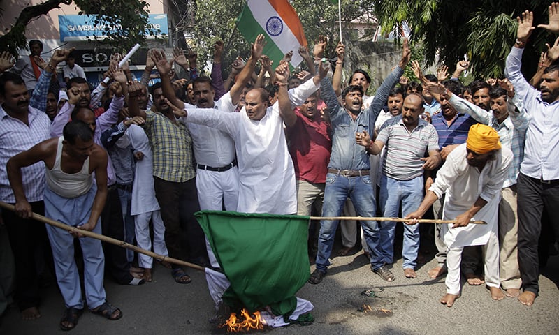 Activists of Jammu and Kashmir Dogra front shout slogans and burn Pakistani flag in Jammu, India-held Kashmir. &mdash; AP