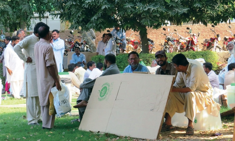 SAHIWAL: Election staff waiting for transport to dispatch material to polling stations in Chichawatni.&mdash;Dawn