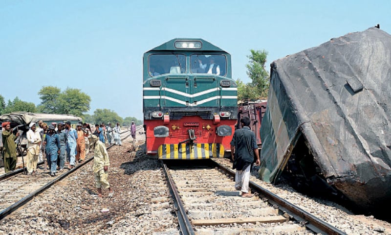 MULTAN: Railway staffers repair the track after removing the damaged bogies. &mdash; APP