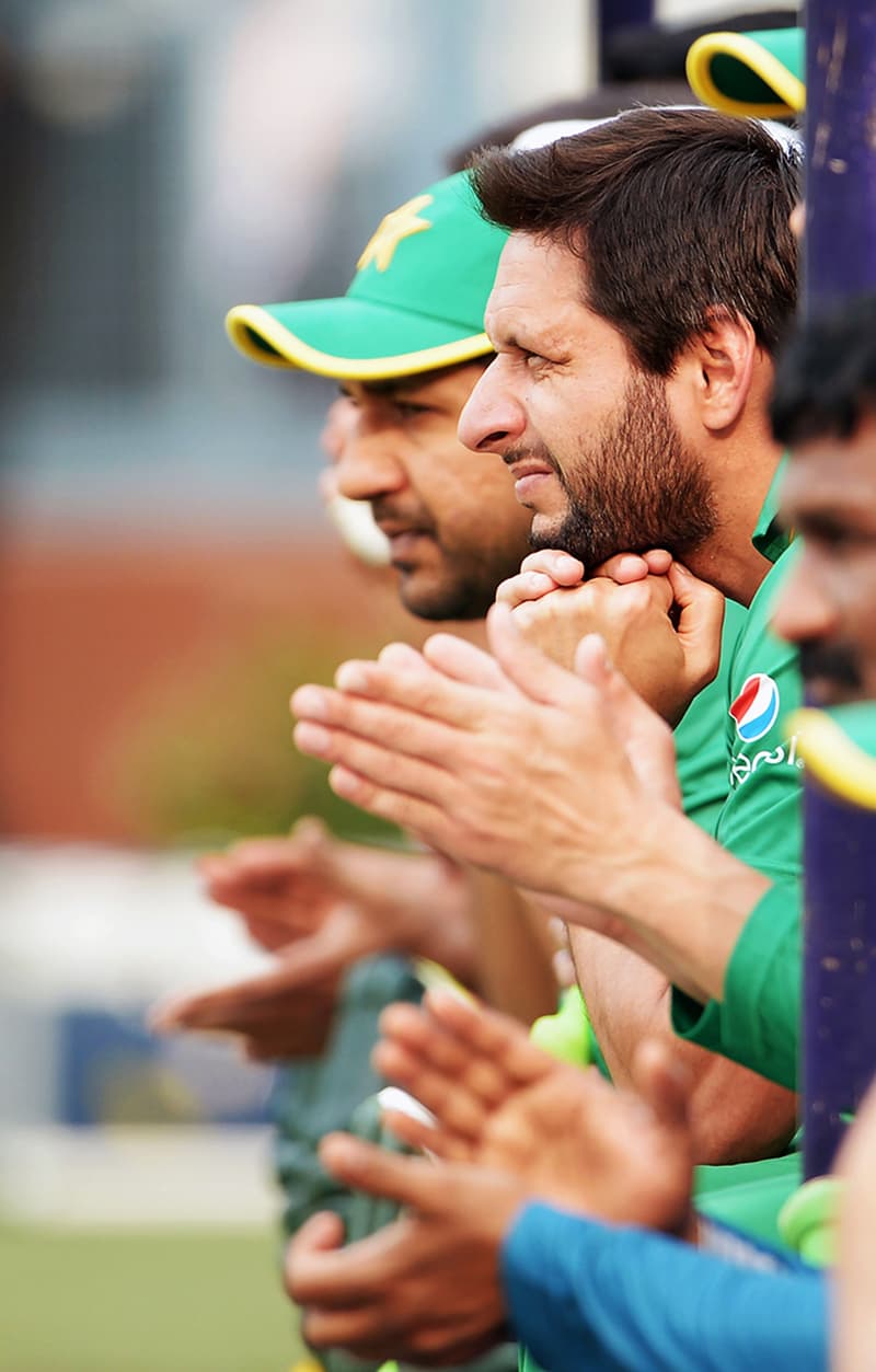 Afridi reacts as he watches a practice match. — AFP