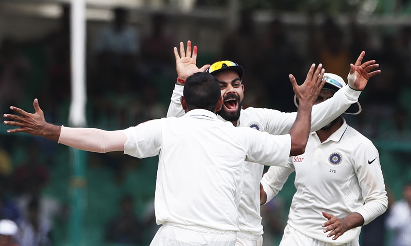 India's Virat Kohli celebrates the wicket of New Zealand's BJ Watling with his team members on the fifth day of their first Test against New Zealand in Kanpur. &mdash; AP