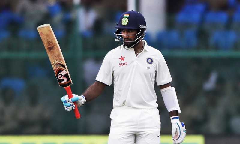 India's Cheteshwar Pujara raises his bats after making half-century against New Zealand during their first Test in Kanpur. — AP India's Cheteshwar Pujara raises his bats after making half-century against New Zealand during their first Test in Kanpur. — AP