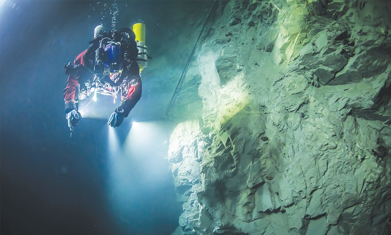 Polish explorer Krzysztof Starnawski is seen examining the limestone crevasse.&mdash;AP