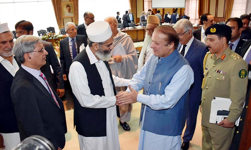 Nawaz Sharif shakes hand with JI Chief Siraj-ul-Haq. —PPI