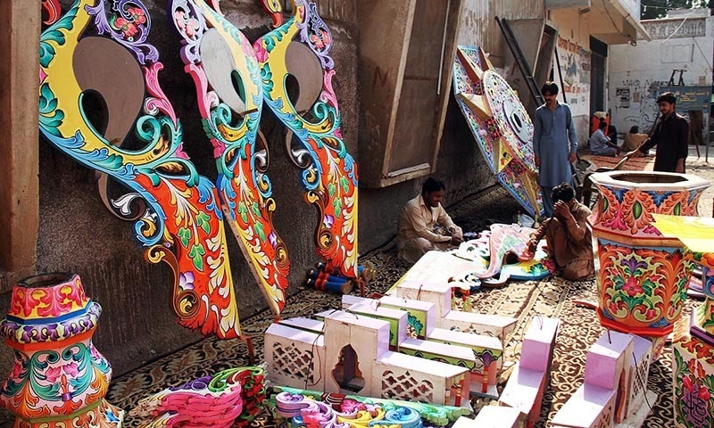 Men seen busy in giving final touches to decoration work of an Alam before re-installation in Hyderabad. — Online