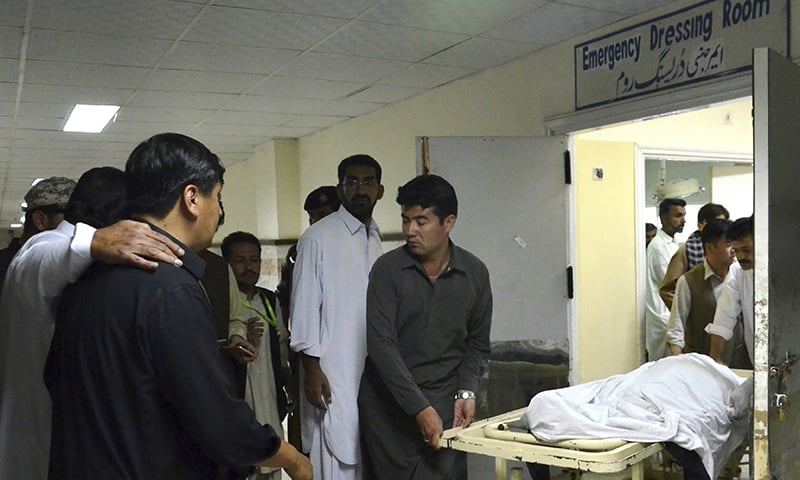 People receive the body of a family member at a local hospital in Quetta.— AP