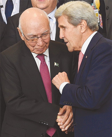FOREIGN Affairs Adviser Sartaj Aziz talks to US Secretary of State John Kerry during a meeting on Afghanistan at the EU headquarters in Brussels on Wednesday.&mdash;AFP