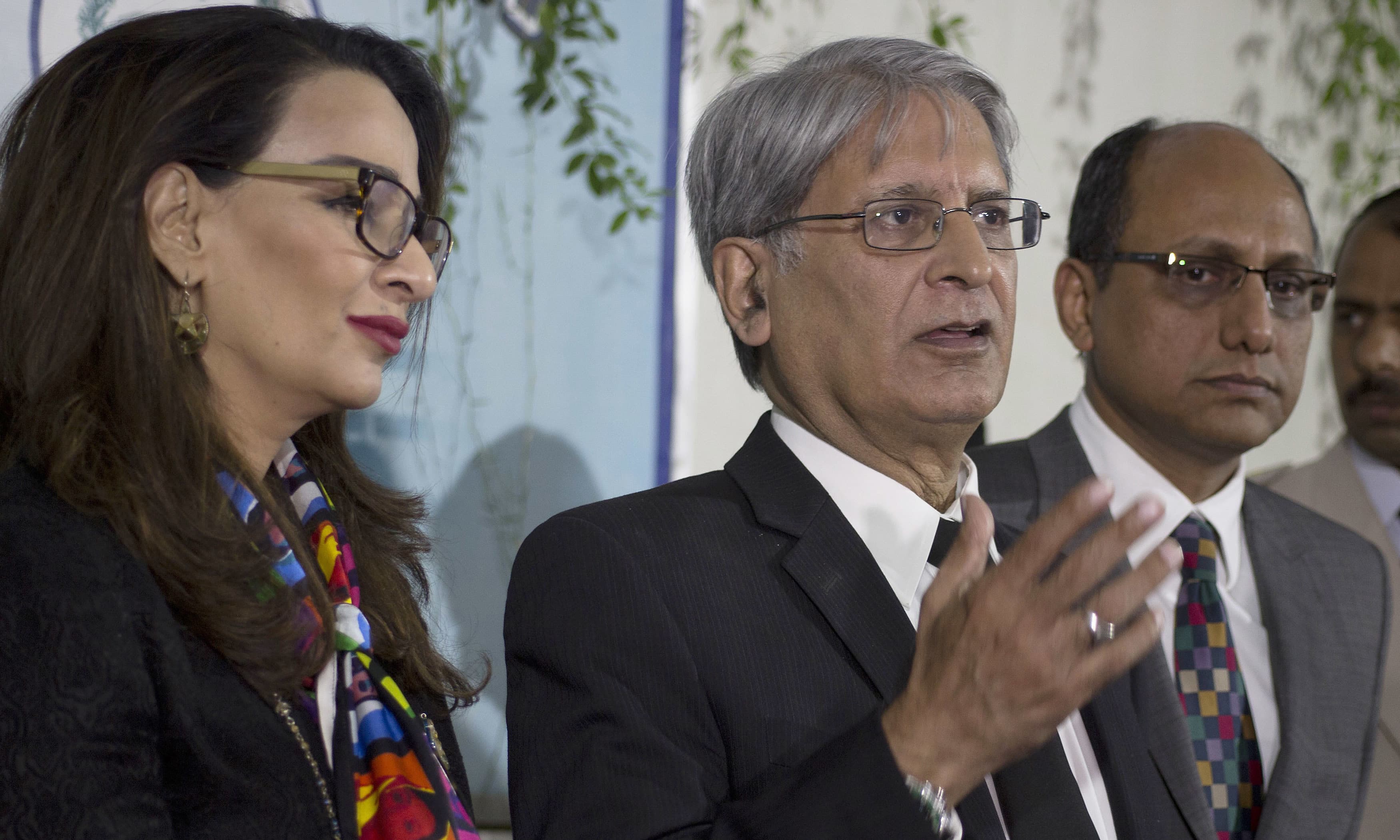 Aitzaz Ahsan addresses media outside the Parliament. —AP