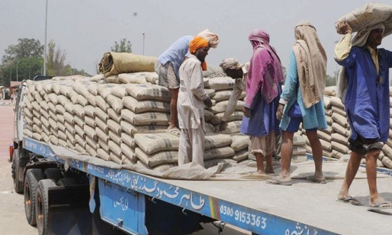 Labourers unload cement bags at a depot. Overall cement despatches rose 8.3pc to 8.976m tonnes in July-Sept 2016-17.—White Star