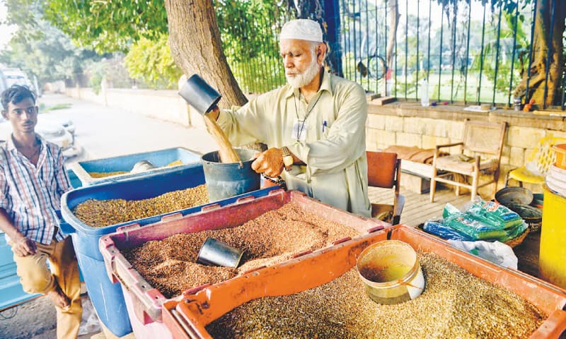 Mohammad Shafiq Sarhadi selling bird food at Kabooter Chowk. / Photos by Fahim Siddiqi / White Star