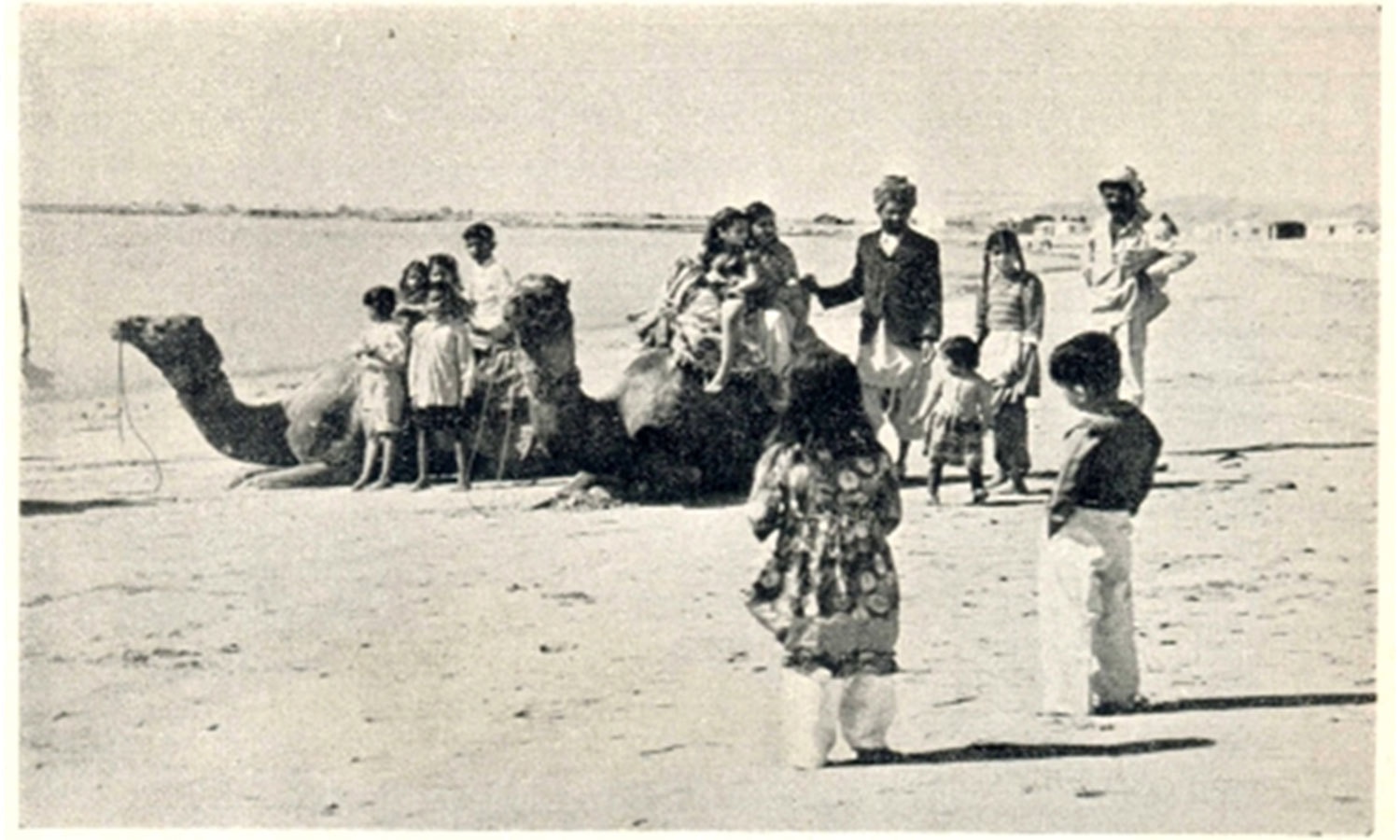 Families enjoy a camel ride on the shores of Clifton Beach in the 1950s. A mammoth shopping mall stands at this very spot today.