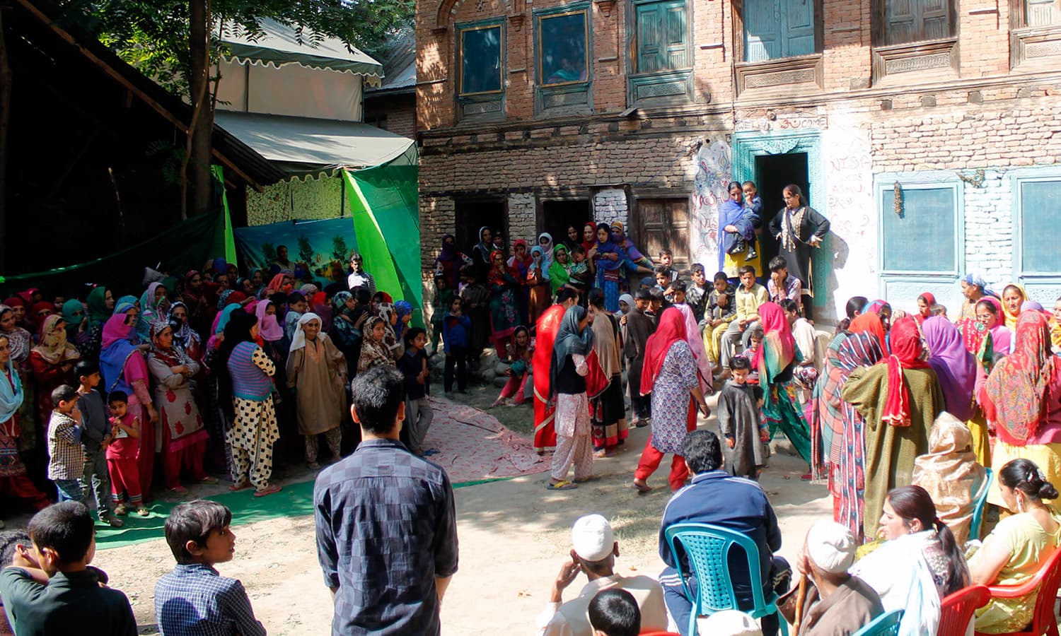 Muslim men, women and children assembly at Raina’s house in Loswani village on the day of wedding. ─ Photo by Vikar Syed