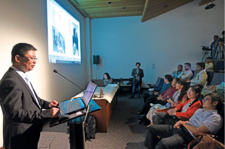 Photographer Jianhua Sun delivers a speech at the PNCA on Thursday.— Photo by Tanveer Shahzad