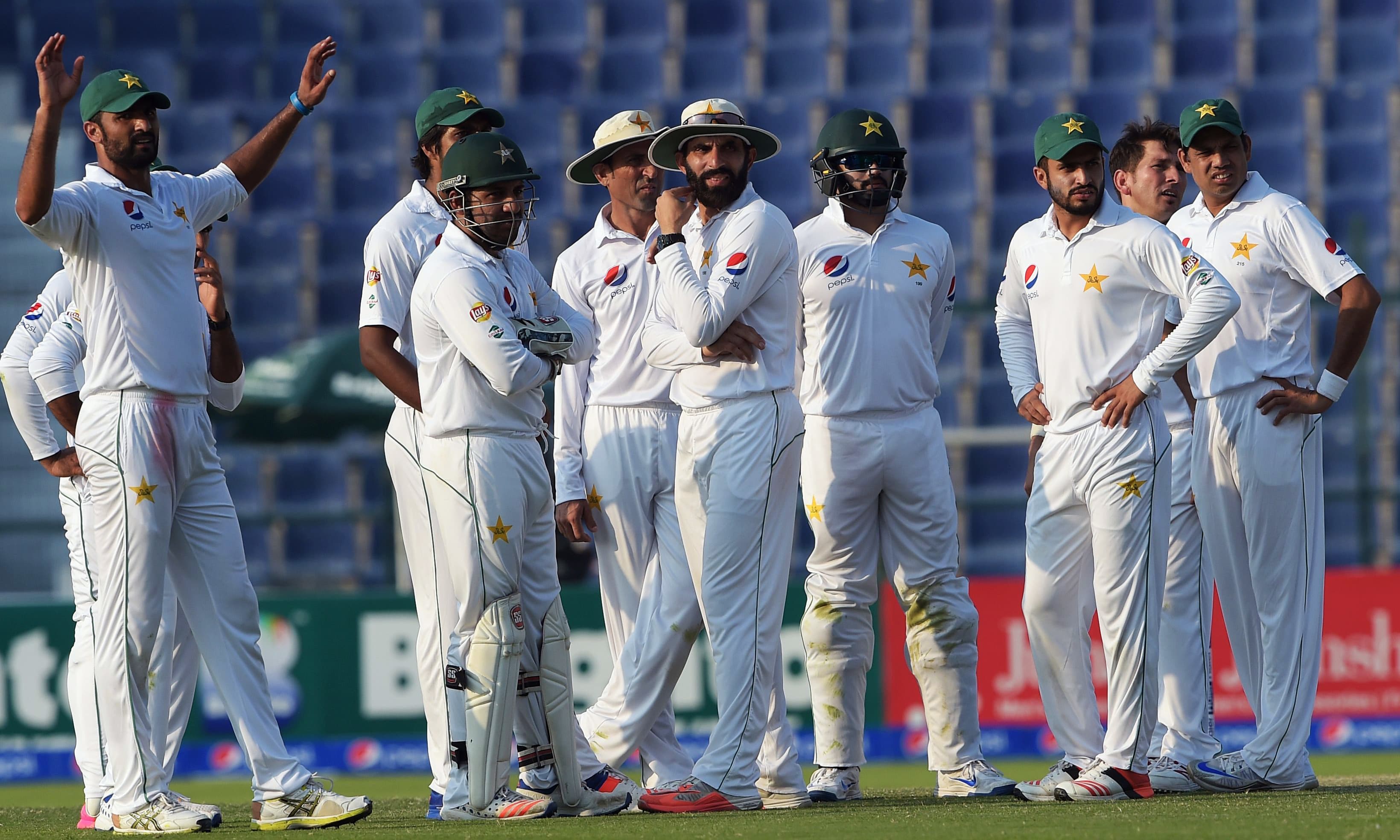Pakistani cricketers wait for a decision from against the West Indies' Darren Bravo. &mdash;AFP