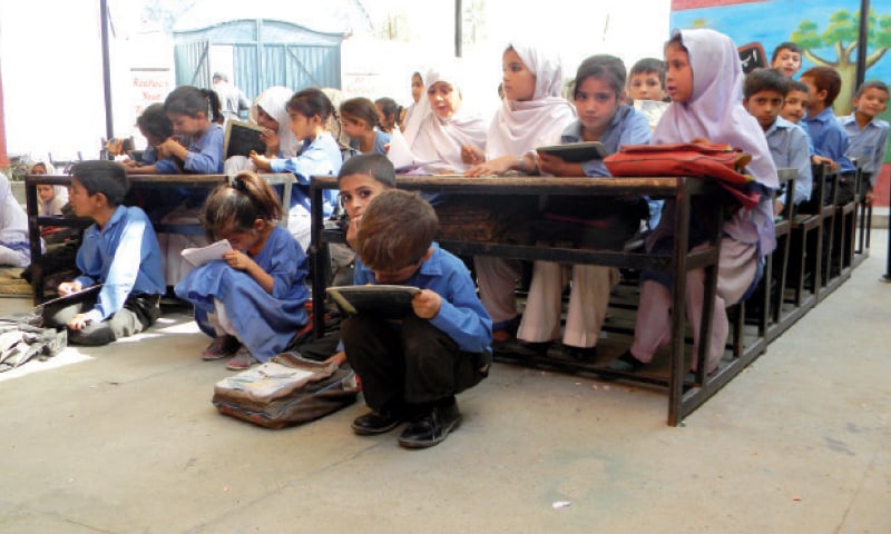 The primary school does not even have rugs for the students to sit on. The other picture shows heaps of garbage near the institution. &mdash; Dawn