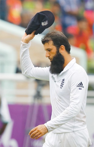 ENGLAND all-rounder Moeen Ali acknowledges the crowd as he leaves the ground, after taking five wickets, at the end of the Bangladesh innings.—AP