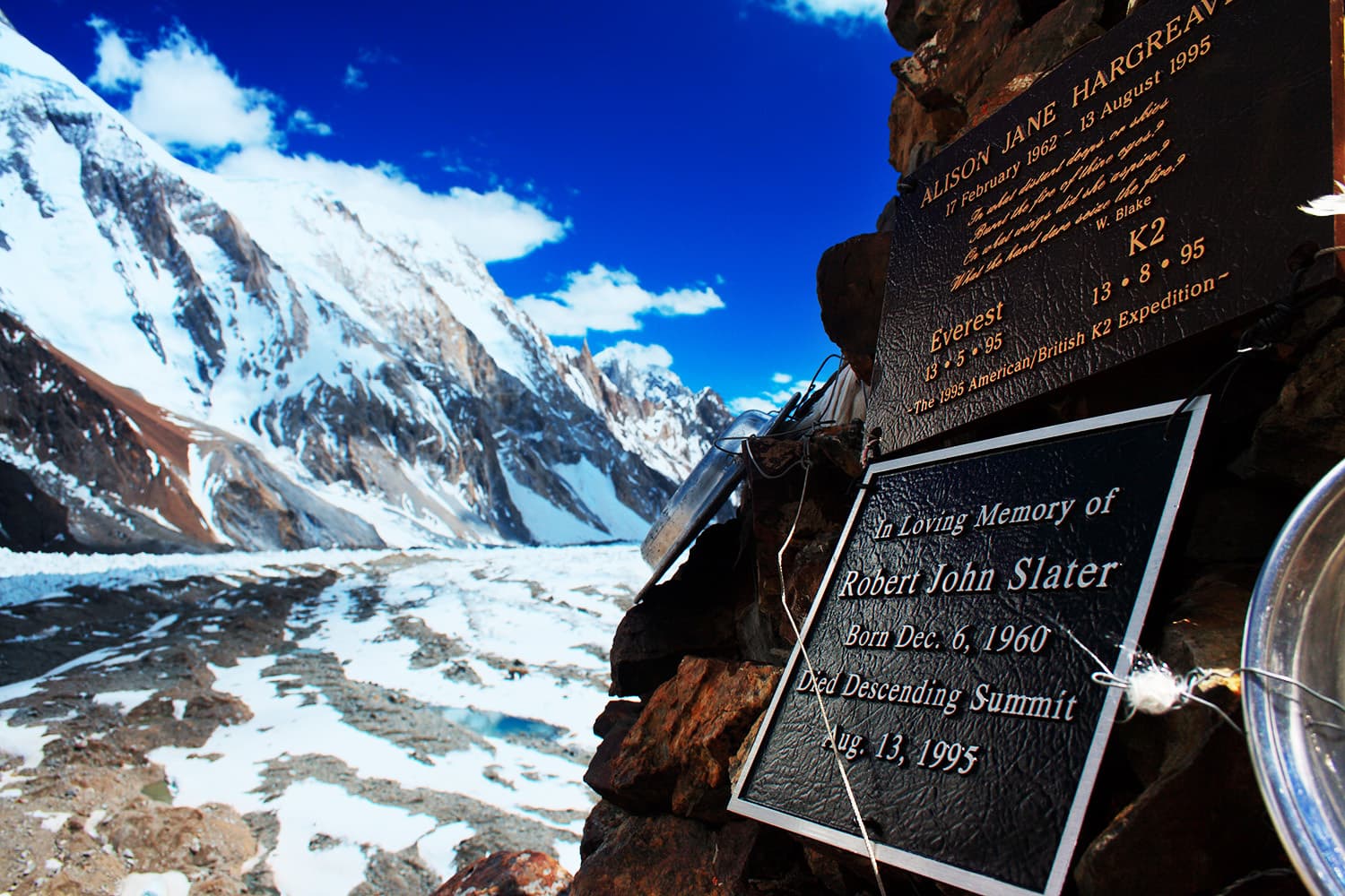 Memorial Plaque of Deceased climber Robert John Slater at the Gilkey Memorial with the view of K2 bacsecamp in the background.—Vasiq Eqbal