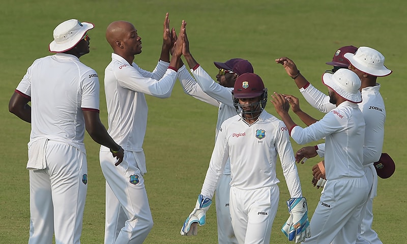 West Indies' cricketers celebrate the dismissal of Misbah-ul-Haq. ─AFP