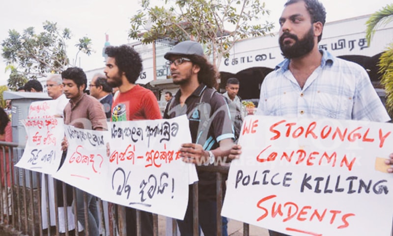 civil society stage a protest outside the Fort Railway Station in Colombo on Oct 24 condemning the killing of two Jaffna University students.