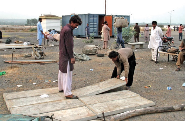 Labourers pack their belongings on Parade Ground where PTI is holding a public gathering. &mdash; INP