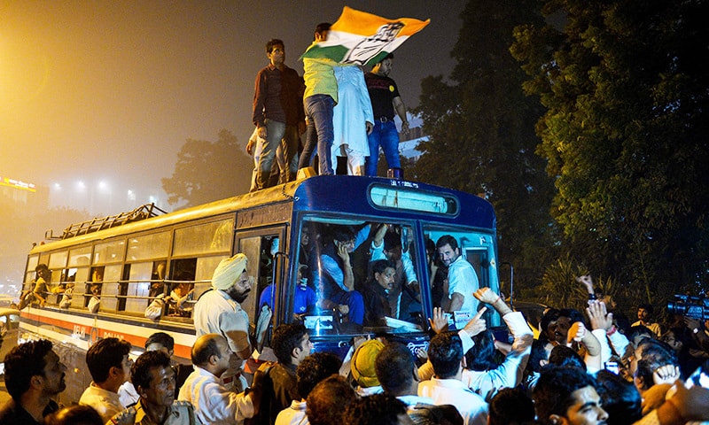 Congress Vice President Rahul Gandhi sits inside a police bus as he gets detained while his supporters cheer for him in New Delhi. —AFP Congress Vice President Rahul Gandhi sits inside a police bus as he gets detained while his supporters cheer for him in New Delhi. —AFP