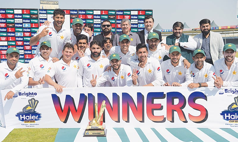 SHARJAH: Pakistan&rsquo;s cricketers pose with the trophy after winning the Test series against the West Indies at the Sharjah Cricket Stadium on Thursday.&mdash;AFP