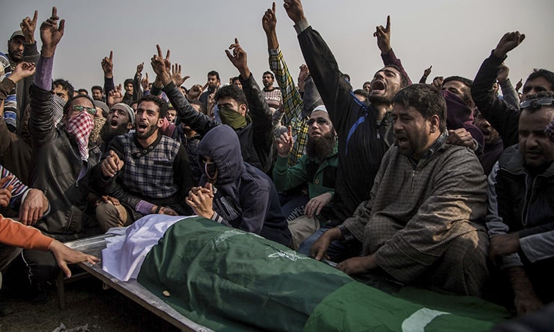 Kashmiri mourners shout pro-freedom slogans near the body of Qaiser Sofi, draped in a Pakistani flag during his funeral procession in Srinagar. ─ AP
