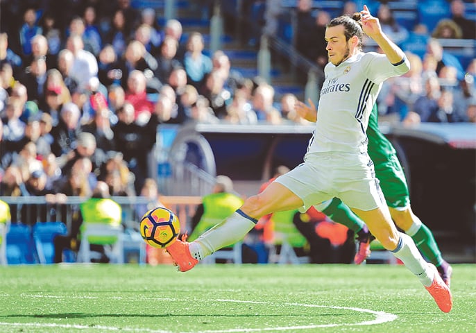 MADRID: Real Madrid’s Gareth Bale controls the ball before scoring a goal during the La Liga match against Leganes at the Santiago Bernabeu Stadium on Sunday.—Reuters