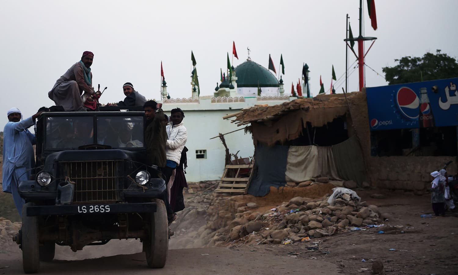 Devotees board a jeep on their return home from the shrine of Sufi saint Shah Noorani after the bomb blast. ─ AFP