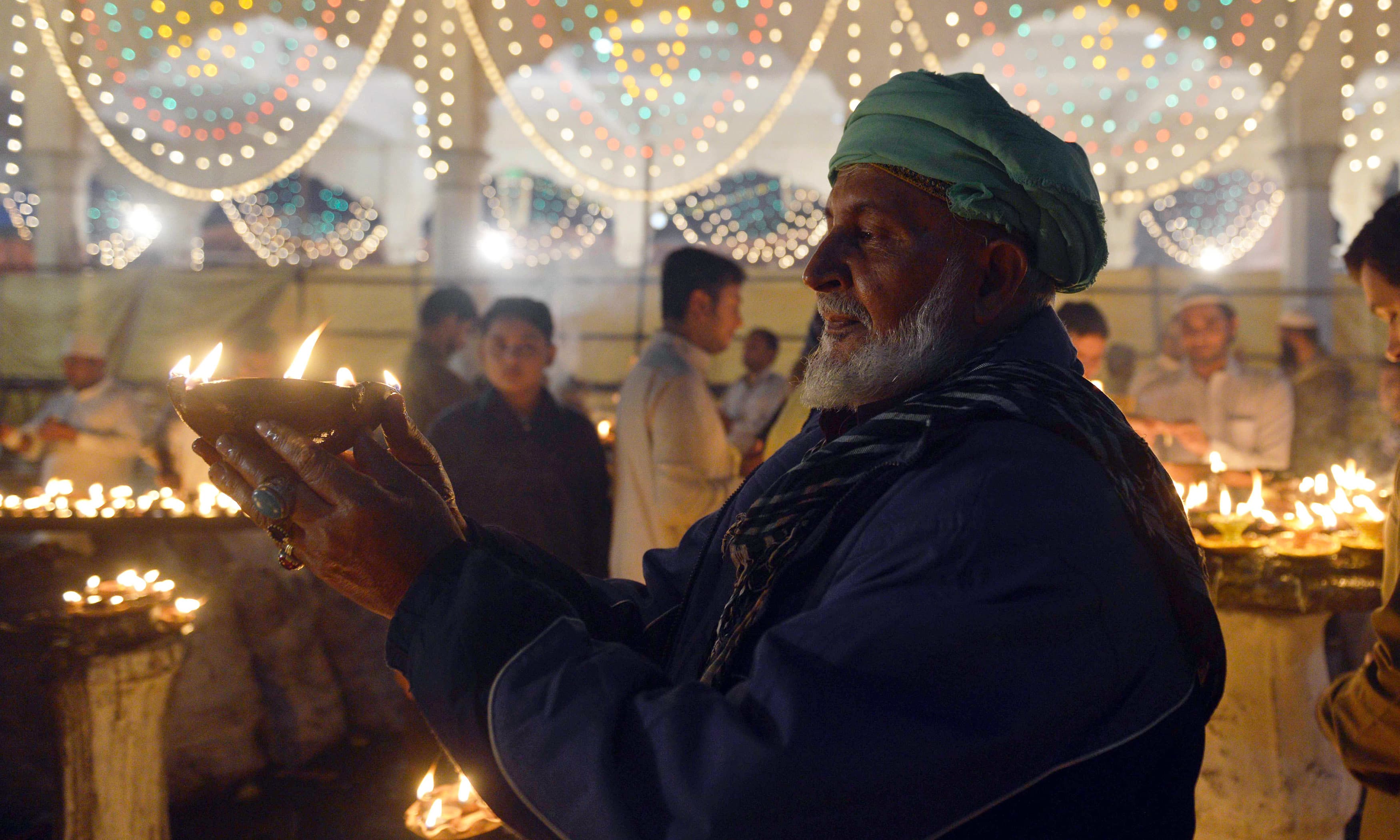 Sufi followers light incense and candles at shrine of Saint Syed Ali bin Osman Al-Hajvery, popularly known as Data Ganj Bakhsh, during the three-day annual 'Urs'.─AFP