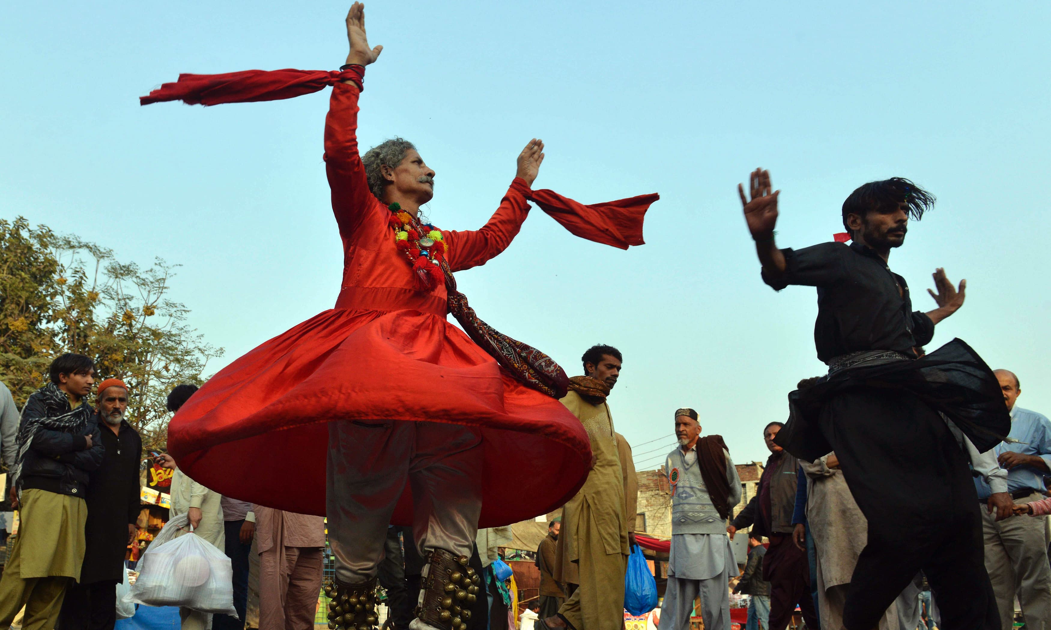 Sufis dance outside the Data Darbar during the three-day annual 'Urs'.─AFP