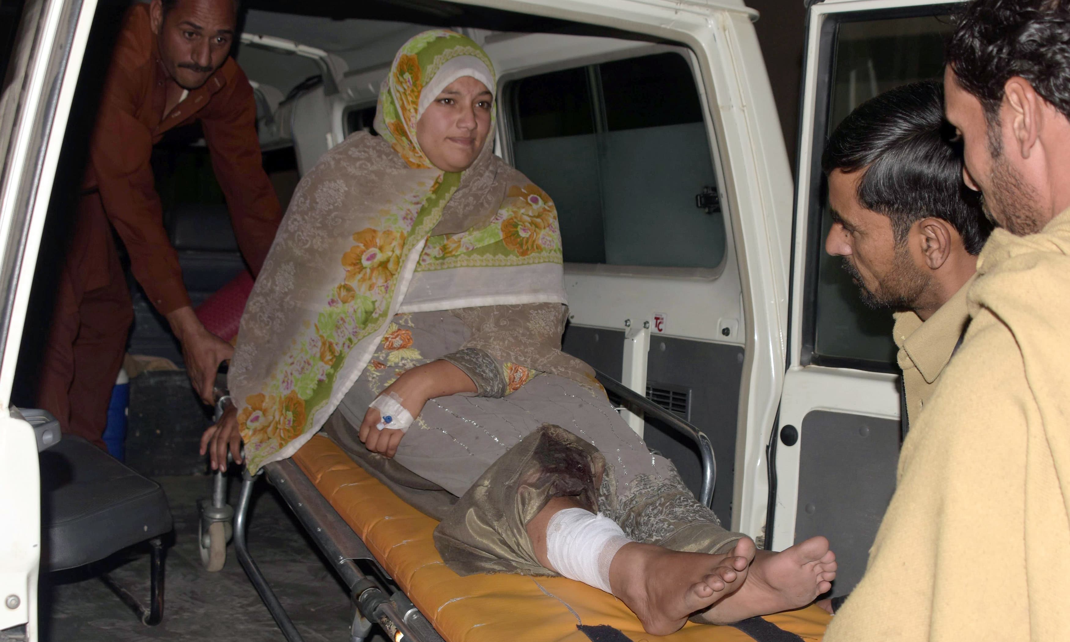 Workers shift an injured Kashmiri woman wounded in cross-border firing by Indian forces. —AFP