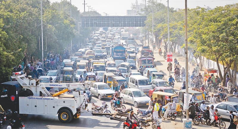 Traffic being diverted to Sir Shah Sulaiman Road from University Road on day one of IDEAS 2016 as some motor-bikers take the wrong way out through the footpaths.—White Star