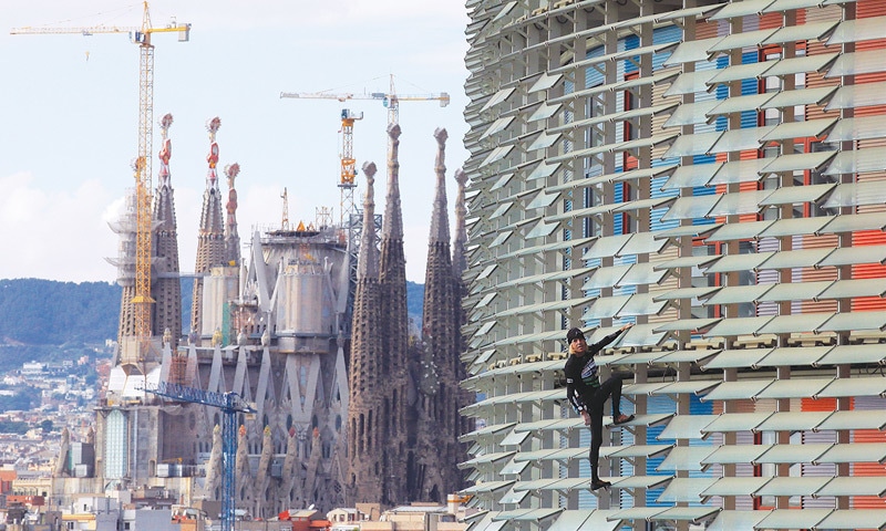Barcelona: Alain Robert, a French climber also known as Spiderman, scales the 38-storey skyscraper Torre Agbar here on Friday.&mdash;AP