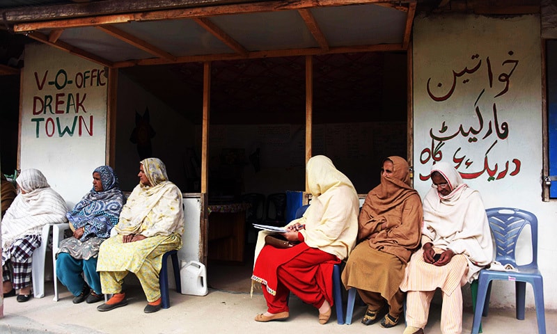 Kashmiri women wait outside the office of social worker Nusrat Yousuf to discuss their social issues with her in the women's market.—AFP