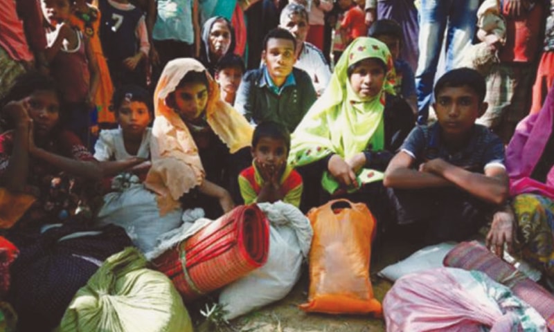 FLEEING Myanmar citizens waiting to enter a refugee camp in Bangladesh.—The Daily Star FLEEING Myanmar citizens waiting to enter a refugee camp in Bangladesh.—The Daily Star