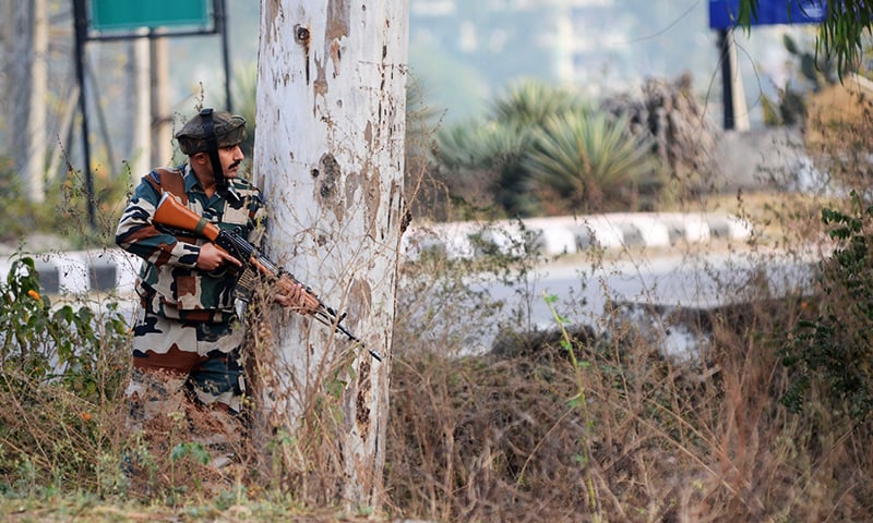 An Indian army soldier stands guard during a gun battle with armed militants at an Indian army base at Nagrota. -AFP