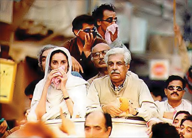 Benazir Bhutto moves through tear gas smoke during a protest rally against the first Nawaz Sharif government. — From the archives