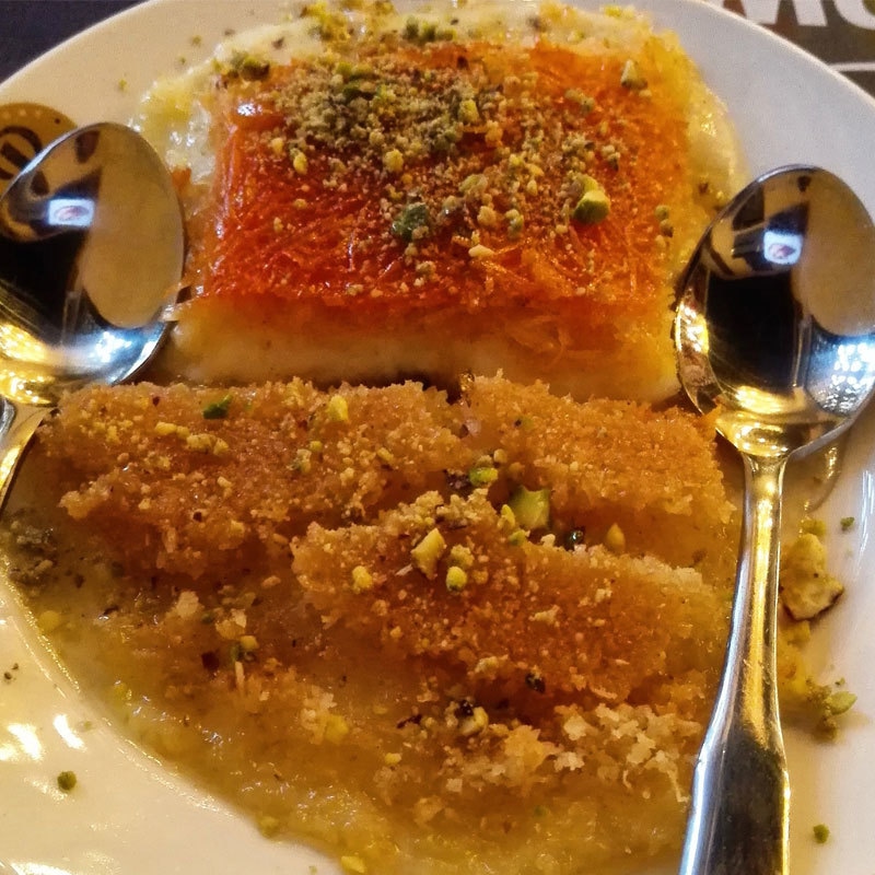 I quickly ordered Kinafeh - a Middle Eastern cheese pastry soaked in sweet, sugar-based syrup. Photo by author.