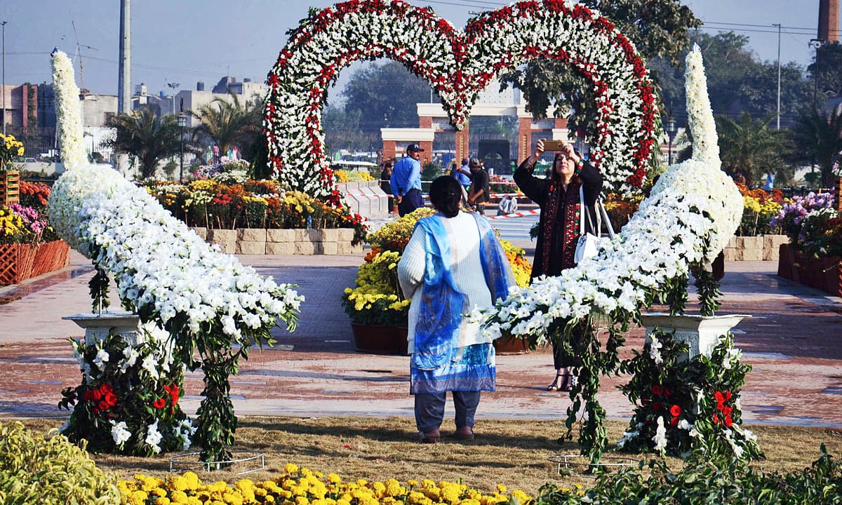 Visitors taking pictures during flowers exhibition at Greater Iqbal Park. —Online