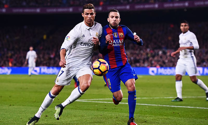 Real Madrid's Portuguese forward Cristiano Ronaldo vies with Barcelona's defender Jordi Alba during the El Clasico. -AFP