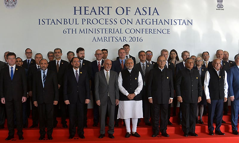 Attendees pose for a photograph at the conference. ─ AFP