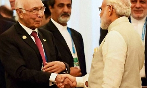 Sartaj Aziz and Indian PM Narendra Modi shake hands upon the former's arrival in India. ─ Photo courtesy Radio Pakistan