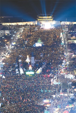 PROTESTERS attend a rally in Seoul on Saturday, calling for South Korean President Park Geun-hye to step down. Many thousands gathered to celebrate the opposition-controlled parliament passing of an impeachment motion against President Park on Friday, which stripped her of her presidential duties until the Constitutional Court rules on her fate.—AP