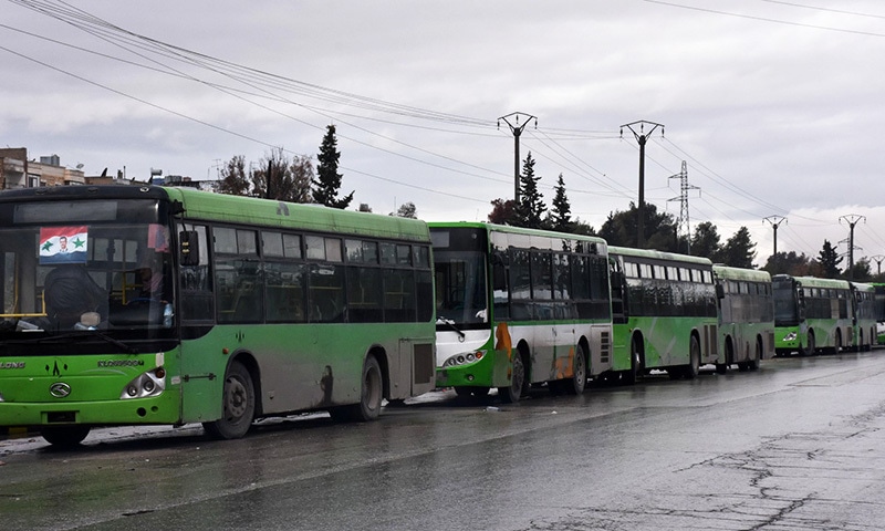 Buses which will be used to evacuate civilians leaving from rebel-held areas of Aleppo are seen waiting on Dec 14.— AFP