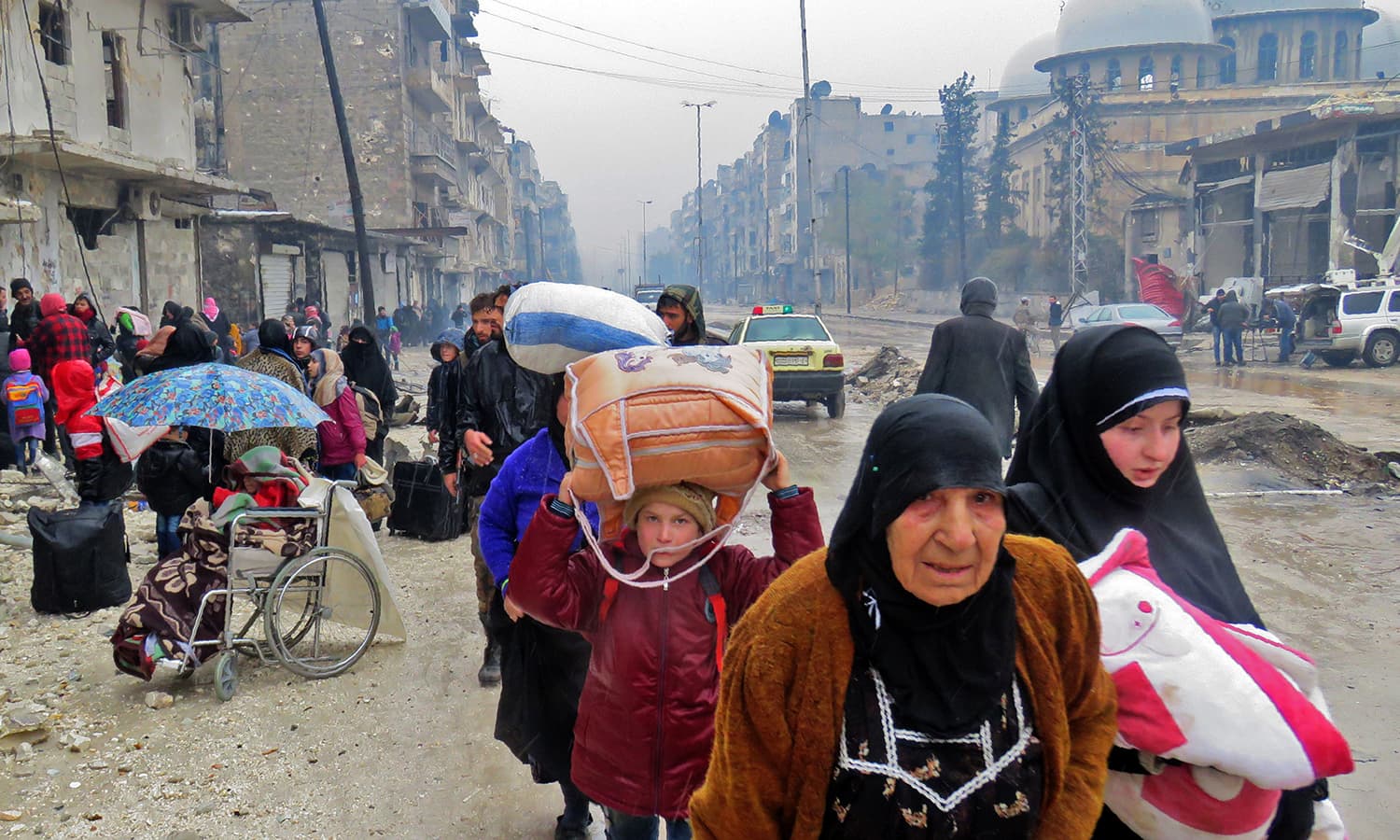 Syrian residents, fleeing violence in the restive Bustan al-Qasr neighbourhood. ─AFP